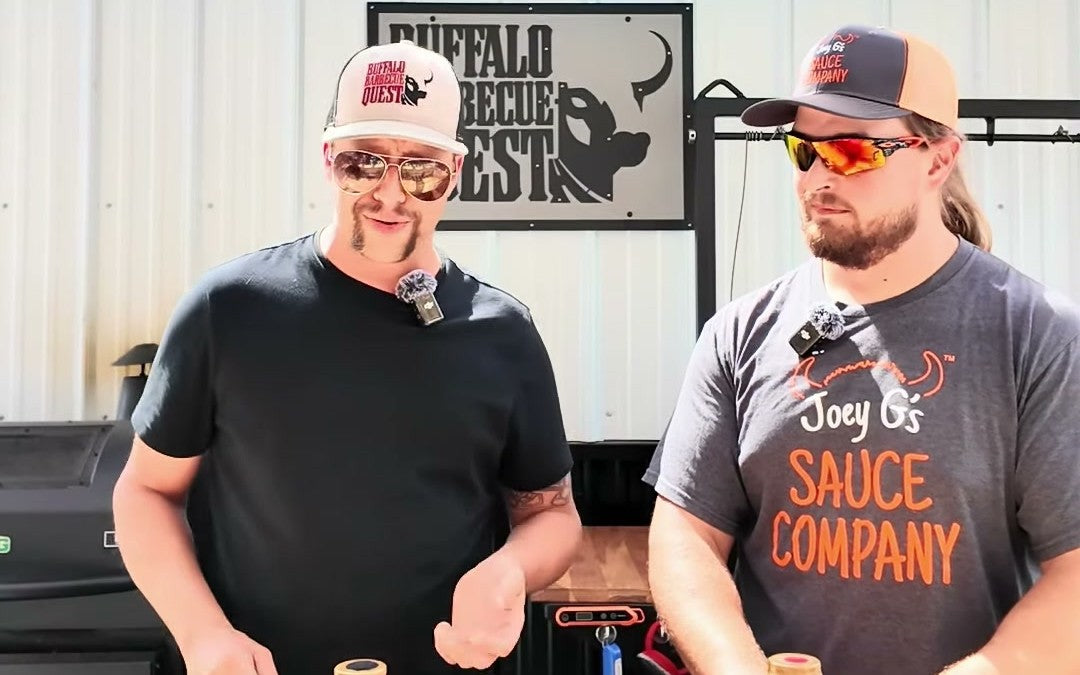 Pat and Joey G under the Buffalo Barbecue Quest sign at the cook station, Joey in a Joey G's Sauce Company shirt, for an episode of Buffalo Barbecue Questions.