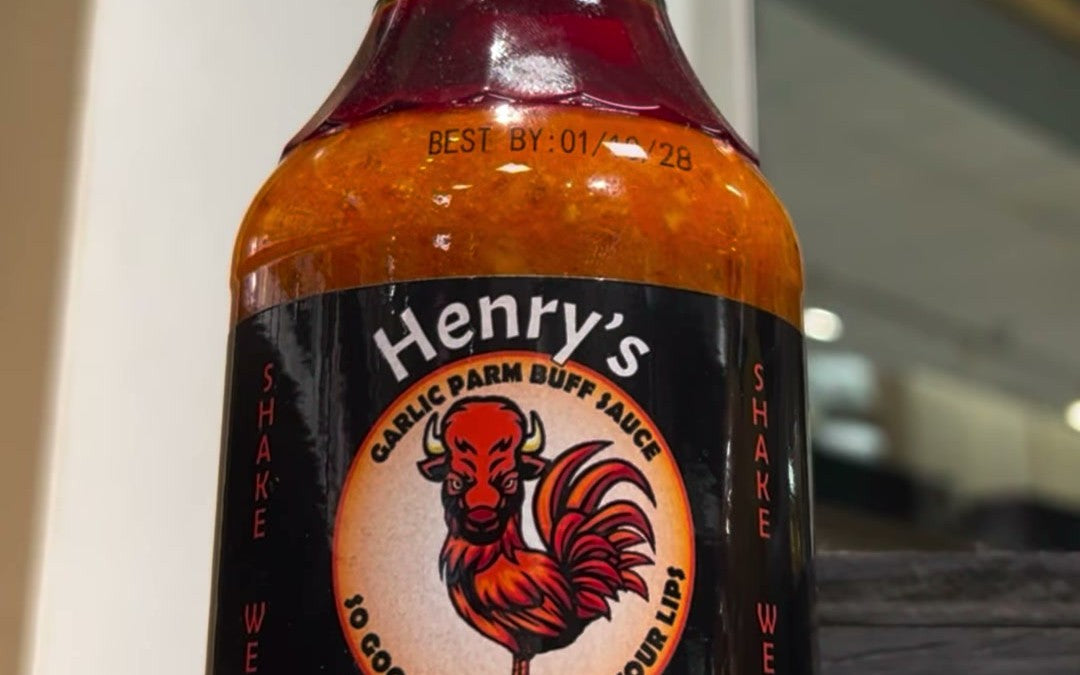 A bottle of Henry's Haus-Sauce Garlic Parm Buffalo, the store's number one seller since opening day.